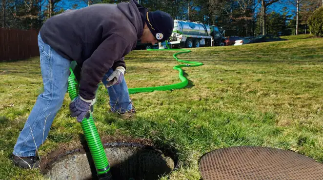 Service technician performing residential septic pumping and drainage maintenance in Hollywood, FL
